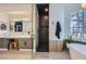 Modern bathroom with walk-in shower, dual vanity, and unique tile design at 176 Tierra Bonita Ct, Henderson, NV 89074