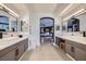 Bright and airy bathroom with dual vanities and an archway leading to the bedroom at 176 Tierra Bonita Ct, Henderson, NV 89074