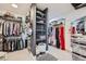 Organized walk-in closet with shelving, hanging rods, and ample storage space for clothes and accessories at 176 Tierra Bonita Ct, Henderson, NV 89074