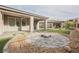 Well maintained backyard with stone pavers, a fire pit and turf at 19 Desert Ivy Ln, Henderson, NV 89011