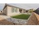 Landscaped backyard showcasing a custom patio, turf area, and privacy fencing at 19 Desert Ivy Ln, Henderson, NV 89011