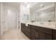 Elegant bathroom featuring double vanity sinks, modern fixtures, and a separate shower with glass door at 19 Desert Ivy Ln, Henderson, NV 89011