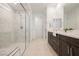 Modern bathroom boasting a glass-enclosed shower, double vanity, and stylish tile flooring at 19 Desert Ivy Ln, Henderson, NV 89011