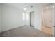 Bright bedroom with gray carpet, a closet, and a view to another room at 19 Desert Ivy Ln, Henderson, NV 89011