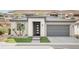 Attractive single-story home with a two-car garage, desert landscaping, and a modern front door at 19 Desert Ivy Ln, Henderson, NV 89011