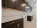 Clean laundry room features a white countertop, dark cabinets, and a sink and faucet on the right at 19 Desert Ivy Ln, Henderson, NV 89011