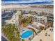 Overhead shot of condo complex, showcasing pool, green spaces, palm trees, and parking at 2044 Mesquite Ln # 202, Laughlin, NV 89029