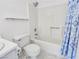 All-white bathroom features a shower-tub combo with a patterned shower curtain at 2044 Mesquite Ln # 202, Laughlin, NV 89029