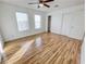Bedroom featuring wood floors, ceiling fan, natural light from windows, and a closet with sliding doors at 2044 Mesquite Ln # 202, Laughlin, NV 89029
