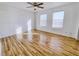 Bedroom features wood floors, ceiling fan, and two windows offering natural light and pleasant views at 2044 Mesquite Ln # 202, Laughlin, NV 89029