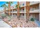 Condominium exterior featuring desert landscaping, a walkway and access to the building's entrances at 2044 Mesquite Ln # 202, Laughlin, NV 89029
