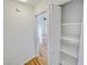 Bright hallway with wood floors, a linen closet, and an open view into a bedroom with a ceiling fan at 2044 Mesquite Ln # 202, Laughlin, NV 89029