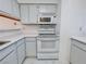 Cozy kitchen featuring a white stove, microwave, and cabinetry for efficient cooking and storage at 2044 Mesquite Ln # 202, Laughlin, NV 89029