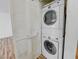 Convenient laundry area featuring a stacked washer and dryer unit, and a louvered closet door at 2044 Mesquite Ln # 202, Laughlin, NV 89029