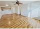 Open floor plan living room with wood floors, ceiling fan, and partial view of the kitchen area at 2044 Mesquite Ln # 202, Laughlin, NV 89029