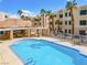 Beautiful community pool with a lounge area and a clear blue sky backdrop for an inviting outdoor experience at 2044 Mesquite Ln # 202, Laughlin, NV 89029