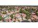 Wide aerial shot showing a residential community with terracotta roofs, lush greenery, and swimming pools on a clear, sunny day at 227 Drysdale Cir, Henderson, NV 89074