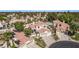 Expansive aerial view showcasing a residential community with lush landscaping, terracotta roofs, and private pools in a sunny locale at 227 Drysdale Cir, Henderson, NV 89074