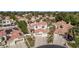 Aerial view of neighborhood featuring homes with tile roofs, lush landscaping and circular driveway at 227 Drysdale Cir, Henderson, NV 89074
