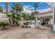 Spacious backyard with covered patio, BBQ area, pool with rock waterfall, and lush palm trees at 227 Drysdale Cir, Henderson, NV 89074