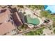 Overhead view showcasing a beautiful backyard with a custom-designed pool, rock waterfall, and patio area surrounded by lush landscaping at 227 Drysdale Cir, Henderson, NV 89074