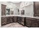 Bathroom with double vanities, decorative lighting, tile floors, and modern dark wood cabinetry at 227 Drysdale Cir, Henderson, NV 89074