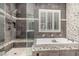Modern bathroom features a shower, soaking tub, shuttered window, and tiled walls with decorative accents at 227 Drysdale Cir, Henderson, NV 89074