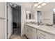 Bathroom featuring granite counters, decorative mirror and lighting, and tiled floor at 227 Drysdale Cir, Henderson, NV 89074