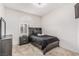 Comfortable bedroom with neutral walls, plush carpet, and a large window with a decorative arch at 227 Drysdale Cir, Henderson, NV 89074