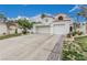 Stylish two-story home with tile roof, an attached two-car garage, and low-maintenance desert landscaping at 227 Drysdale Cir, Henderson, NV 89074