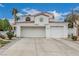 Two-story home featuring a tile roof, manicured landscaping, and an attached two-car garage at 227 Drysdale Cir, Henderson, NV 89074