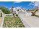 Inviting two-story home boasting tile roof, attached two-car garage, and attractive desert landscaping at 227 Drysdale Cir, Henderson, NV 89074