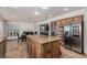Open kitchen featuring a large island, stainless steel appliances, and views of the dining area at 227 Drysdale Cir, Henderson, NV 89074