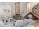 Bright, open living room featuring a fireplace, staircase, and travertine flooring at 227 Drysdale Cir, Henderson, NV 89074