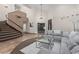 Spacious living room with high ceilings, stairs, and a comfortable gray sectional sofa at 227 Drysdale Cir, Henderson, NV 89074