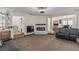 Open-concept living room with a fireplace and bar area, perfect for entertaining guests at 227 Drysdale Cir, Henderson, NV 89074