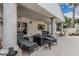 Covered patio with lounge chairs, decorative columns, and outdoor lighting for relaxation and entertaining at 227 Drysdale Cir, Henderson, NV 89074