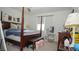 Cozy bedroom with four-poster bed, vanity, and neutral carpet at 230 Carmel Sky St, Las Vegas, NV 89138