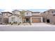 Beautiful two-story home featuring a two-car garage, desert landscaping, and a welcoming front entrance at 230 Carmel Sky St, Las Vegas, NV 89138