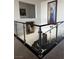 Staircase with glass railing and artwork on walls at 230 Carmel Sky St, Las Vegas, NV 89138