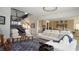 Open-concept living room with staircase, connecting to a modern kitchen and comfortable seating at 230 Carmel Sky St, Las Vegas, NV 89138
