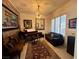 Stylish sitting room with dark wood furniture, artwork, and a textured accent wall at 230 Carmel Sky St, Las Vegas, NV 89138