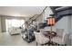 Bright open-concept living room featuring tile floors and a staircase with glass railings at 230 Carmel Sky St, Las Vegas, NV 89138