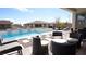 Backyard oasis featuring a sparkling pool, hot tub, ample seating, and privacy at 230 Carmel Sky St, Las Vegas, NV 89138