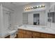 Well-lit bathroom with double sinks, vanity, toilet, and shower-tub combination at 2504 Soldier Creek Ct, Las Vegas, NV 89106