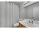 Bathroom features a white shower curtain, modern fixtures, and vanity space at 2504 Soldier Creek Ct, Las Vegas, NV 89106