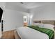 Bright bedroom with a bed and green throw blanket with access to the bathroom at 2504 Soldier Creek Ct, Las Vegas, NV 89106