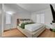 This cozy bedroom features a large window and a comfortable bed with a green throw blanket at 2504 Soldier Creek Ct, Las Vegas, NV 89106