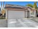 View of a single-story home with desert landscaping, a two-car garage, and solar panels at 2504 Soldier Creek Ct, Las Vegas, NV 89106