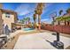 Spacious backyard with a refreshing pool, sports court, palm trees and patio area at 266 Cordero Dr, Henderson, NV 89074